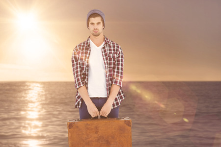 Portrait of confident man holding bag against sunset of a beautiful dayの写真素材