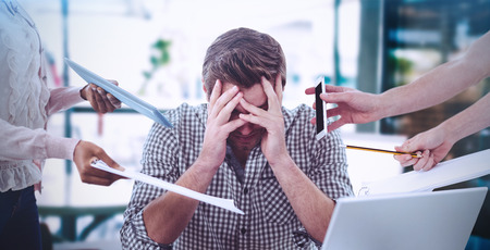 Composite image of businessman stressed out at work