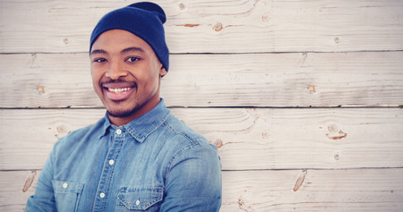 Handsome man against wooden backgroundの写真素材