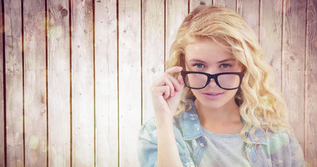 Portrait of businesswoman wearing eyeglasses posingagainst wooden planksの写真素材