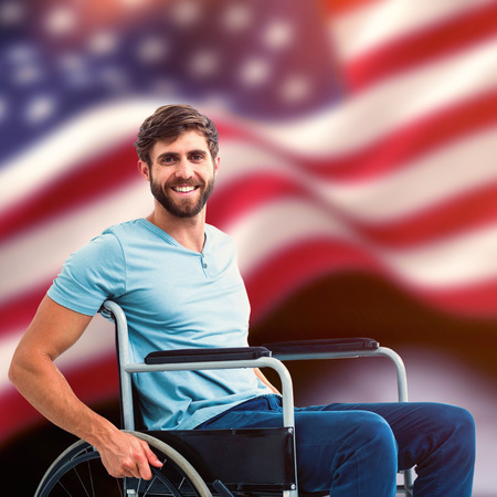 Young man in wheelchair against composite image of digitally generated united states national flagの写真素材