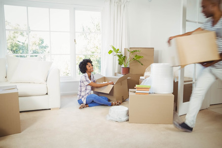 Happy couple with boxes in the living room