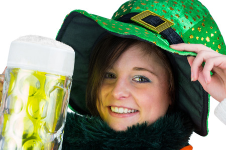 Pretty brunette celebrating Saint Patricks day on white backgroundの写真素材