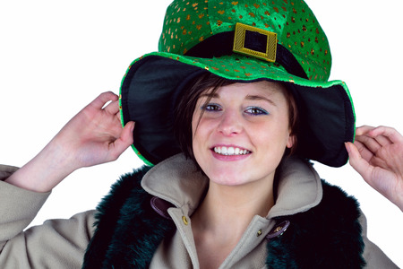 Pretty brunette wearing green hat on white backgroundの写真素材