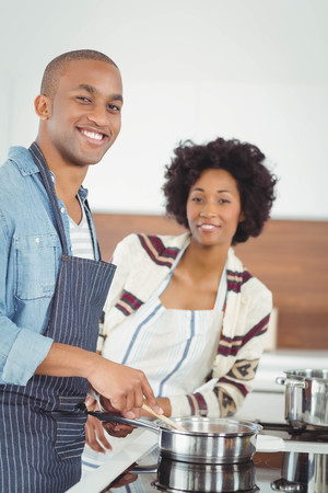 Happy couple cooking together in the kitchenの写真素材