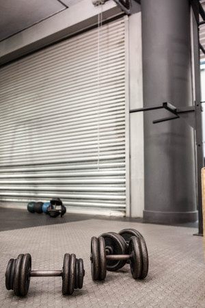 Dumbbells on the floor at the crossfit gymの写真素材