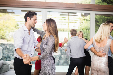 Group of young friends dancing at the party