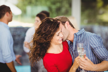 Romantic couple having drinks at the partyの写真素材