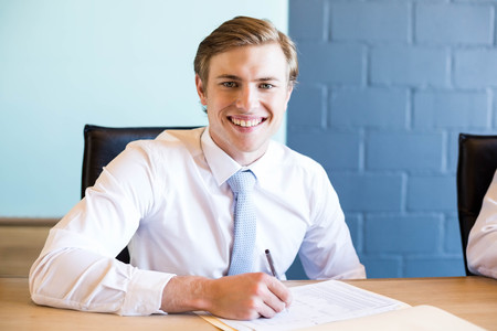 Young businessman in business meeting in conference room at officeの写真素材