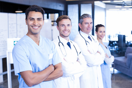 Portrait of medical team standing together and smiling in hospitalの写真素材