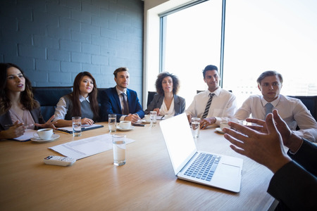 Businesspeople having a discussion in conference room in office