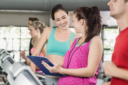 Female trainer discussing about performance at crossfit gym