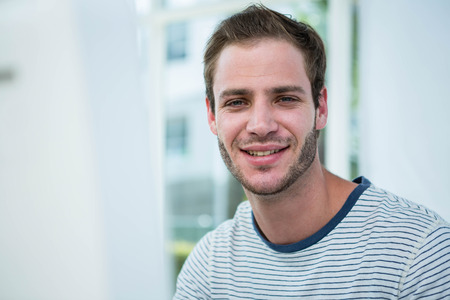 Handsome hipster working in a bright office