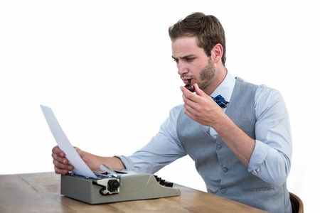 Handsome man using old fashioned typewriter on white backgroundの写真素材