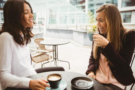 Friends chatting over coffee in cafe