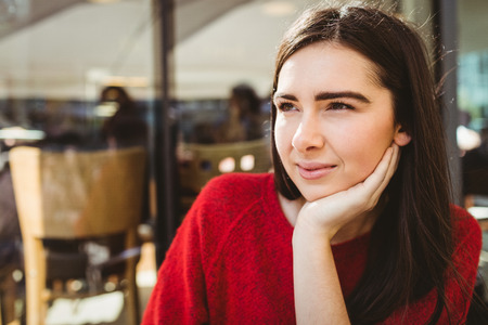 Portrait of thoughtful woman in cafeの写真素材