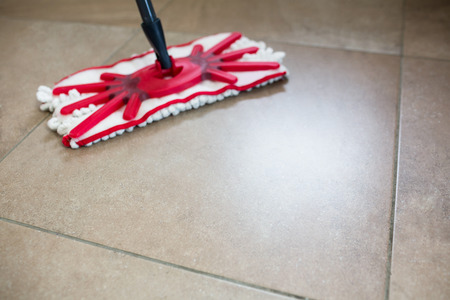 View of a mop swiping the kitchen floorの写真素材