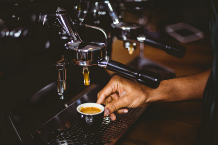 Waiter making a cup of coffee at the coffee shopの写真素材