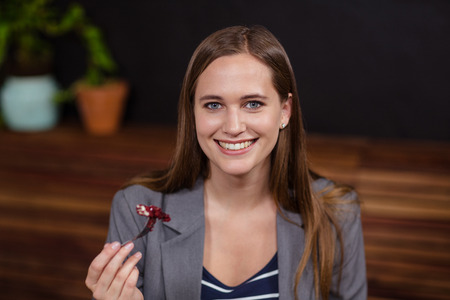 Woman eating a cake in a cafeの写真素材