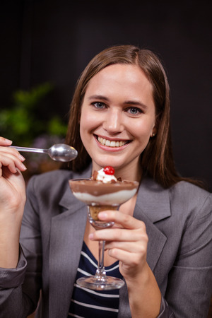 Pretty woman about to eat dessert in the barの写真素材
