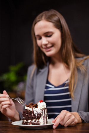 Pretty woman about to eat pie in the barの写真素材