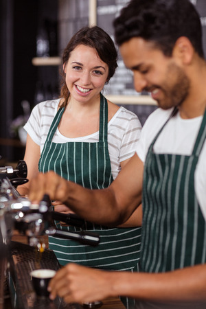 Smiling baristas working in the barの写真素材