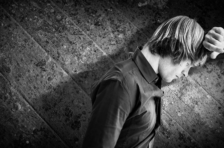 Hipster businessman looking out the window against wooden floorの写真素材