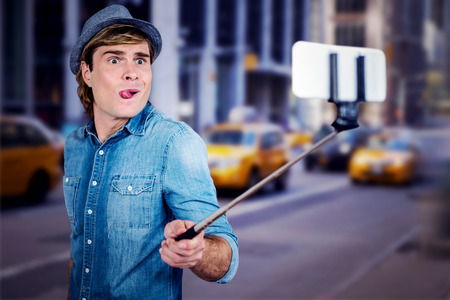 Funny hipster taking picture  against blurry new york streetの写真素材