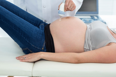 Pregnant woman receiving ultrasound treatment in hospital