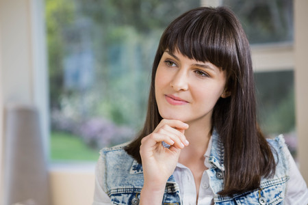 Close-up of beautiful young woman thinkingの写真素材