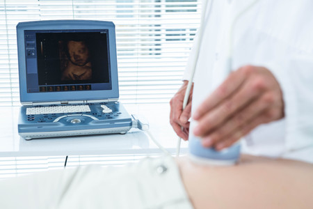 Pregnant woman undergoing ultrasound test in hospital