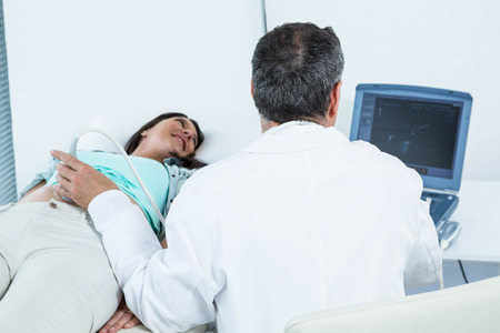 Pregnant woman undergoing ultrasound test in hospital