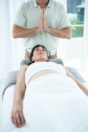 Pregnant woman receiving a massage from masseur at the health spaの写真素材