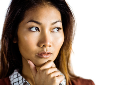 Serious businesswoman holding her chin on white backgroundの写真素材