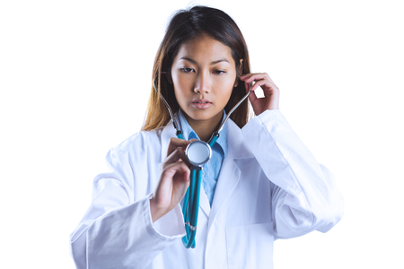 Asian doctor holding her stethoscope on white backgroundの写真素材