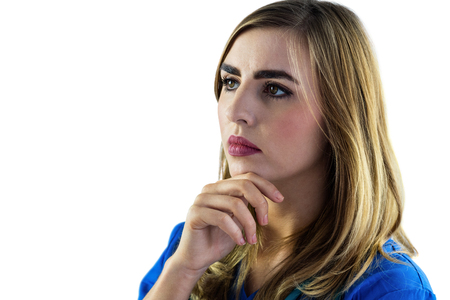 Nurse touching her chin on white backgroundの写真素材