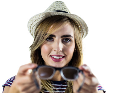 Smiling woman holding glasses on white screen
