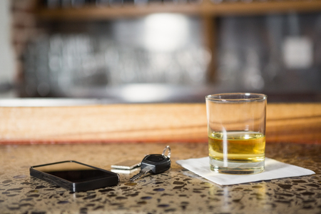 View of whiskey, smartphone and car keys in a barの写真素材