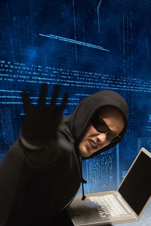 Hacker using laptop to steal data