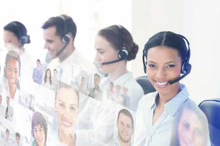 Business people with headsets using computers  against business people