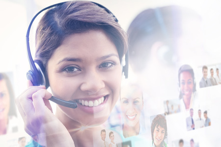 Business people against pretty smiling businesswoman working in a call centre