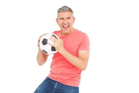 Happy man holding a soccer ball on white backgroundの写真素材