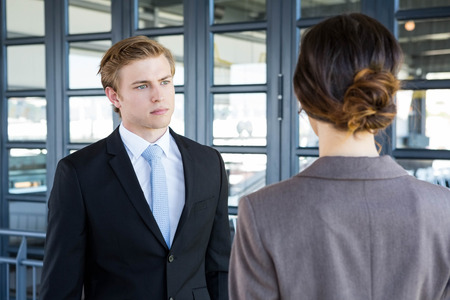 Businessman interacting with his business colleague in officeの写真素材