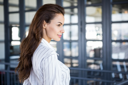 Close-up of beautiful young businesswoman in officeの写真素材