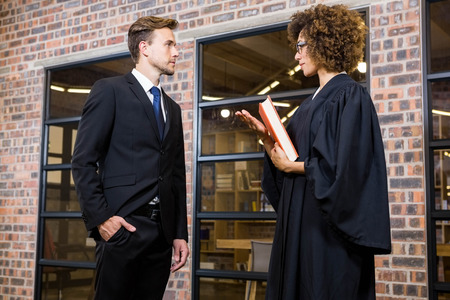 Lawyer interacting with businessman in officeの写真素材