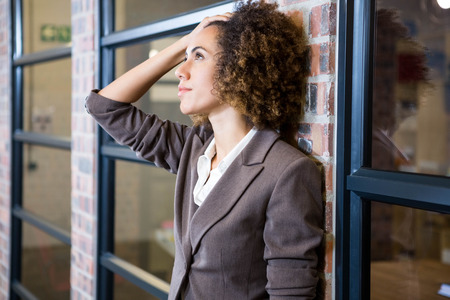 Frustrated businesswoman with hand on forehead in office
