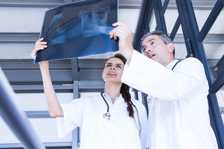 Doctors examining a x report in hospital