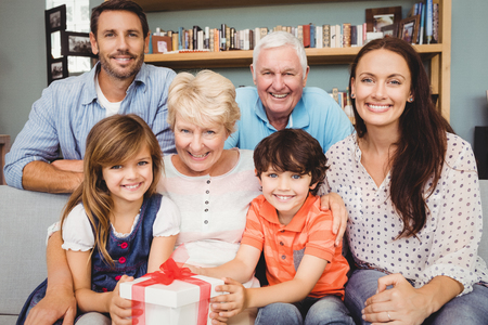 Portrait of happy family with gift box at home