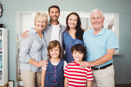 Portrait of smiling family standing at home