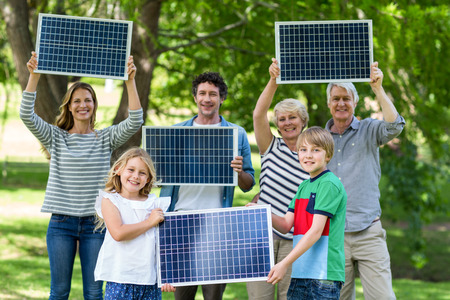 Family holding blackboard together in the parkの写真素材